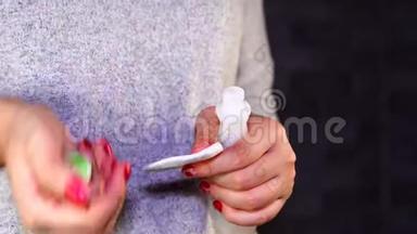 女人用指甲油去除剂去除红色指甲油。 女士去掉指甲油。 女人的手除掉红指甲